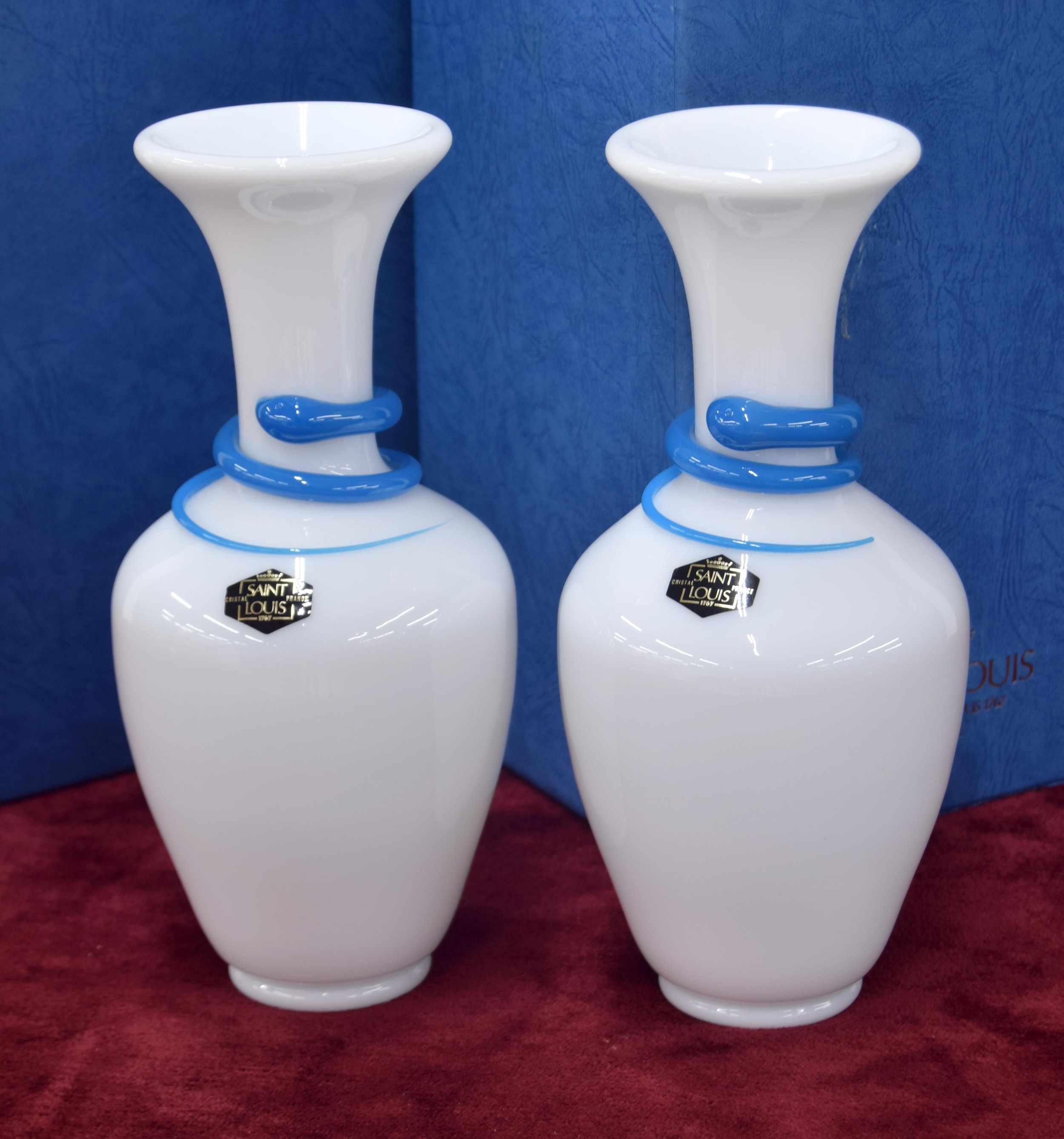 Pair of Saint-Louis opaque glass snakes vases with blue trail decoration, signed, 8" high; each with