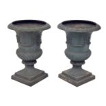 Pair of weathered cast iron campagna garden urns upon square stepped bases, 31" high, 22.5" diameter