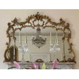 Large and impressive giltwood and gesso overmantel mirror in the George III style, carved with