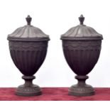 Pair of heavy cast metal urns and covers int he Georgian manner, each with fluted bodies upon