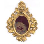 Late 19th century Italian Florentine oval giltwood wall mirror, with an oval plate to a leaf and