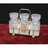 Atkin Brothers silver plated pickle set, inset with three cut-glass jars and stoppers in a plated