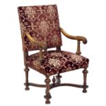 Carolean design walnut upholstered armchair, the frame with acanthus carved arms on turned legs