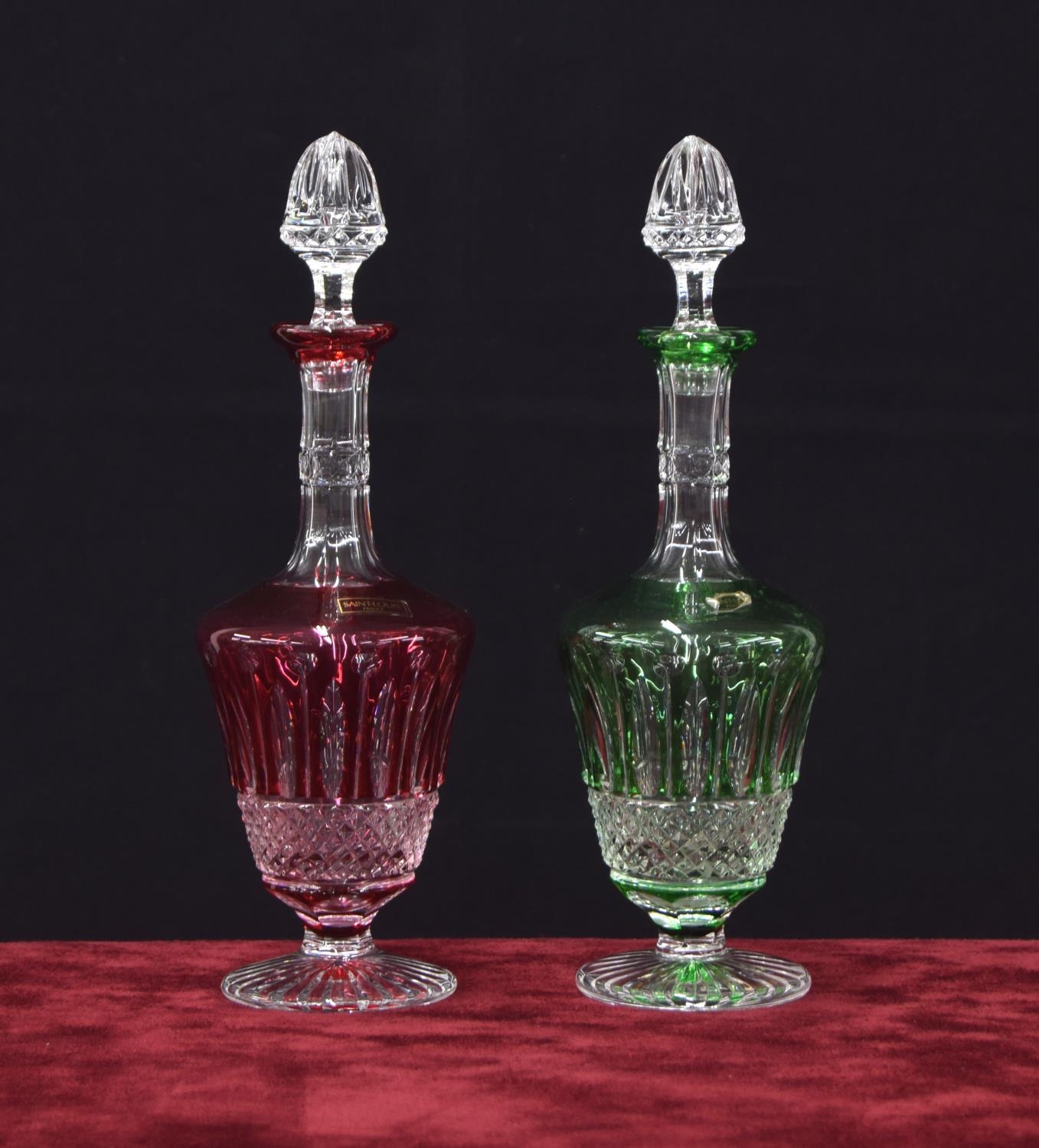 Matched pair of Saint-Louis crystal glass overlaid liqueur decanters, in green and red, 10" high