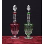 Matched pair of Saint-Louis crystal glass overlaid liqueur decanters, in green and red, 10" high