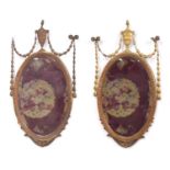 Pair of neo-classic style oval giltwood and gesso wall mirrors, each with bevelled glass panels