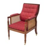 Good quality modern bergere library armchair in the Regency manner, with silk button-back cushions