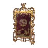 George III style carved and gilded wall mirror, with rococo scroll and rocaille work and trailing