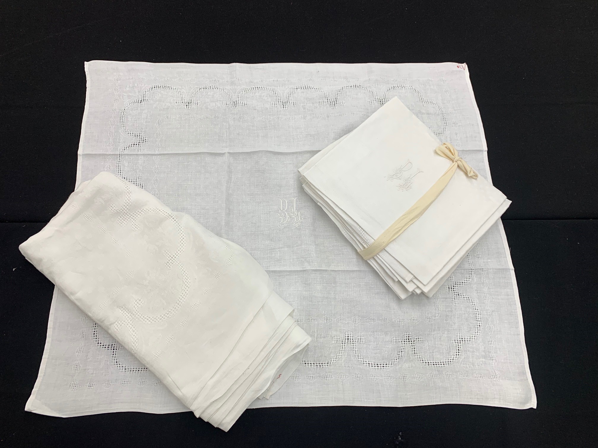 French linen cloth, 71" x 57" approx; with twelve extra large napkins monogrammed 'BL' for the