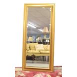 Large modern rectangular gilt framed wall mirror inset with a bevelled glass, 67" x 31"