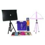 Three music stands/ledges; together with a selection of sheet music to include bowed strings,