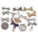 Collection of silver, gilded and metal bow design brooches for fob watches; George III 1787 shilling