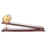 Reproduction Dent type inclined gravity clock, the 3.5" brass dial within a drum casing, upon a gilt