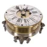 Brass circular eight day table clock striking on a bell beneath the base, the 5" silvered chapter