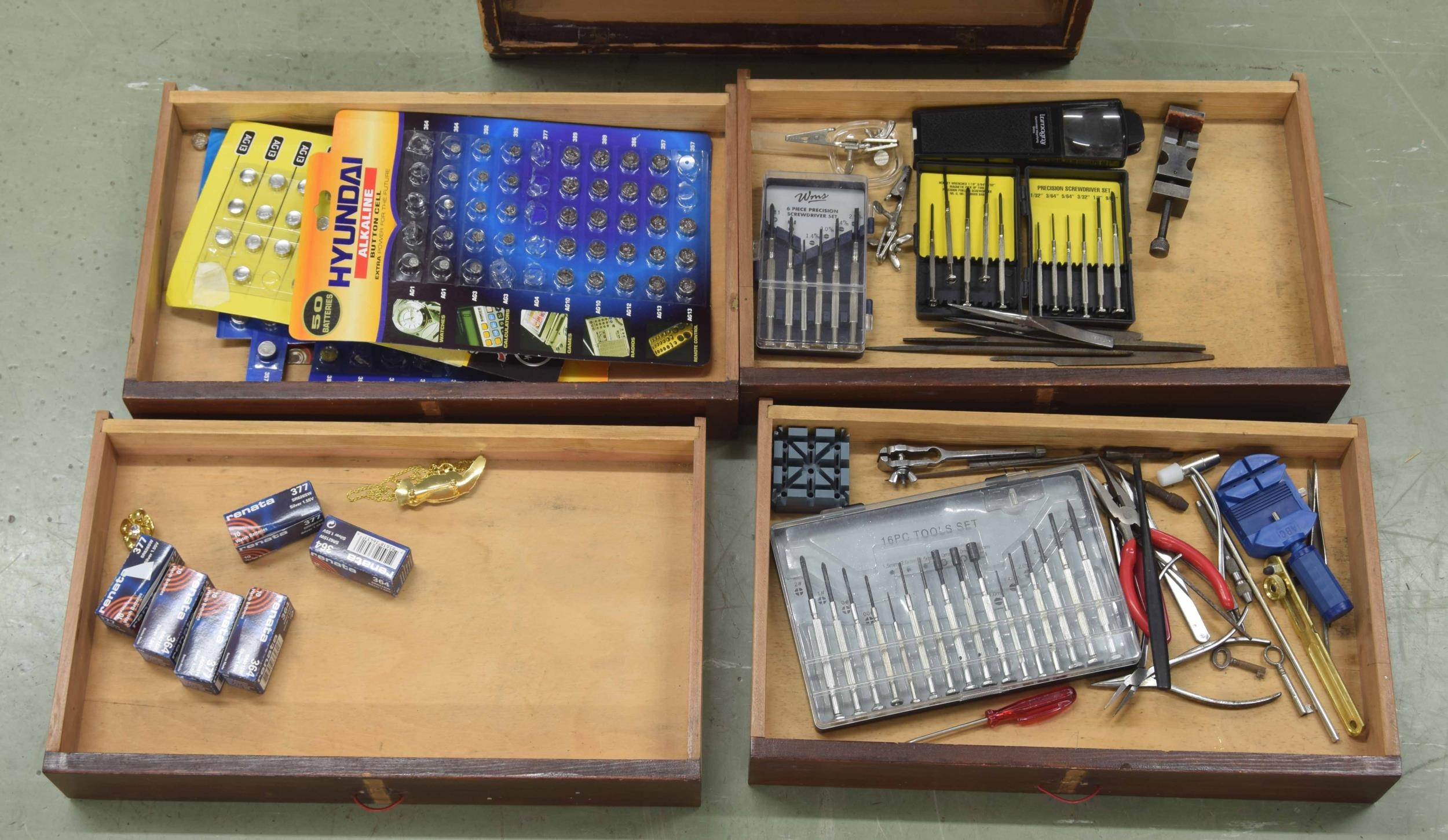 Small pine chest of four long drawers containing small watch tools including pliers, precision screw