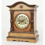 German walnut two train mantel clock striking on a gong, the 5" silvered dial within a pillared