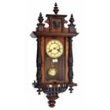 Walnut and ebonised two train Vienna style wall clock, the 5" cream dial within a pillared and