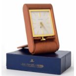 Jaeger-LeCoulte 8-day travel clock, the silvered dial within a folding light leather case 4.25" long