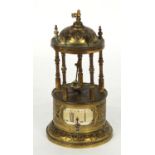Small circular brass novelty conical clock in the form of a temple, with aperture to the base