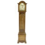 Good mahogany three train grandmother clock, the movement playing on five rods, the 8.5" brass