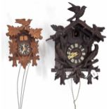 Black Forest two train cuckoo clock, the 4.75" dial within a chalet case applied with carved birds