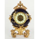 French gilt metal and pottery two train novelty moon shaped mantel clock, the P. Japy & Cie movement