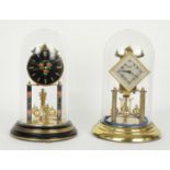 Two contemporary torsion clocks with ball pendulums by Vioteta & Halles, both under glass domes