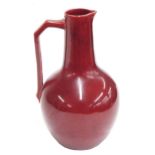Christopher Dresser design for Lear Pottery jug, decorated in a deep ruby red glaze, inscribed