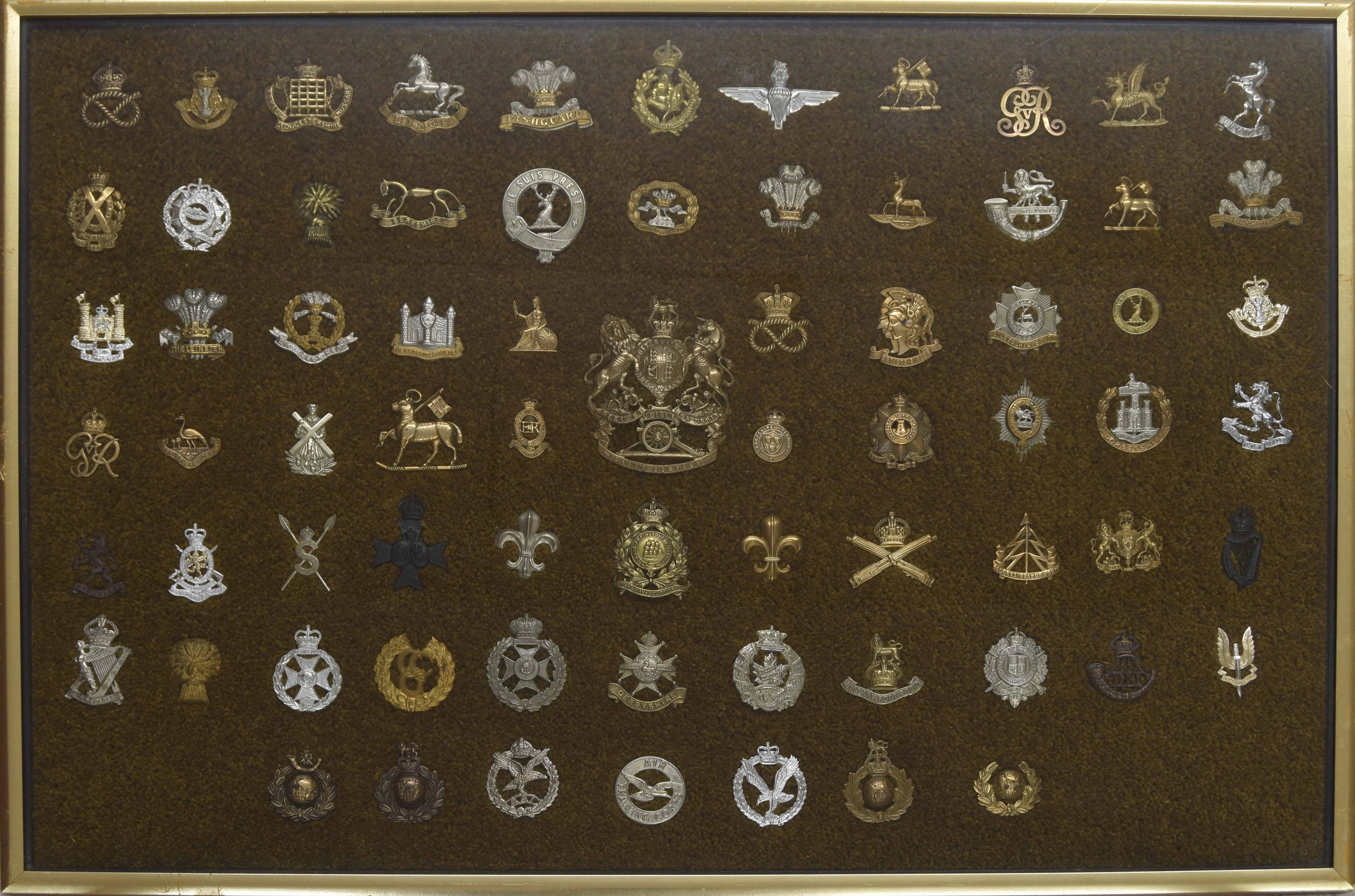 Military Regimental cap badges - large collection of seventy-two examples mounted in a display