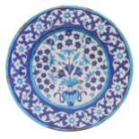 Iznik delft stoneware pottery plate, decorated with an urn with far reaching floral display,