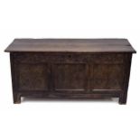 Charles II carved oak coffer, the hinged planked top opening to reveal a candle box, over a triple