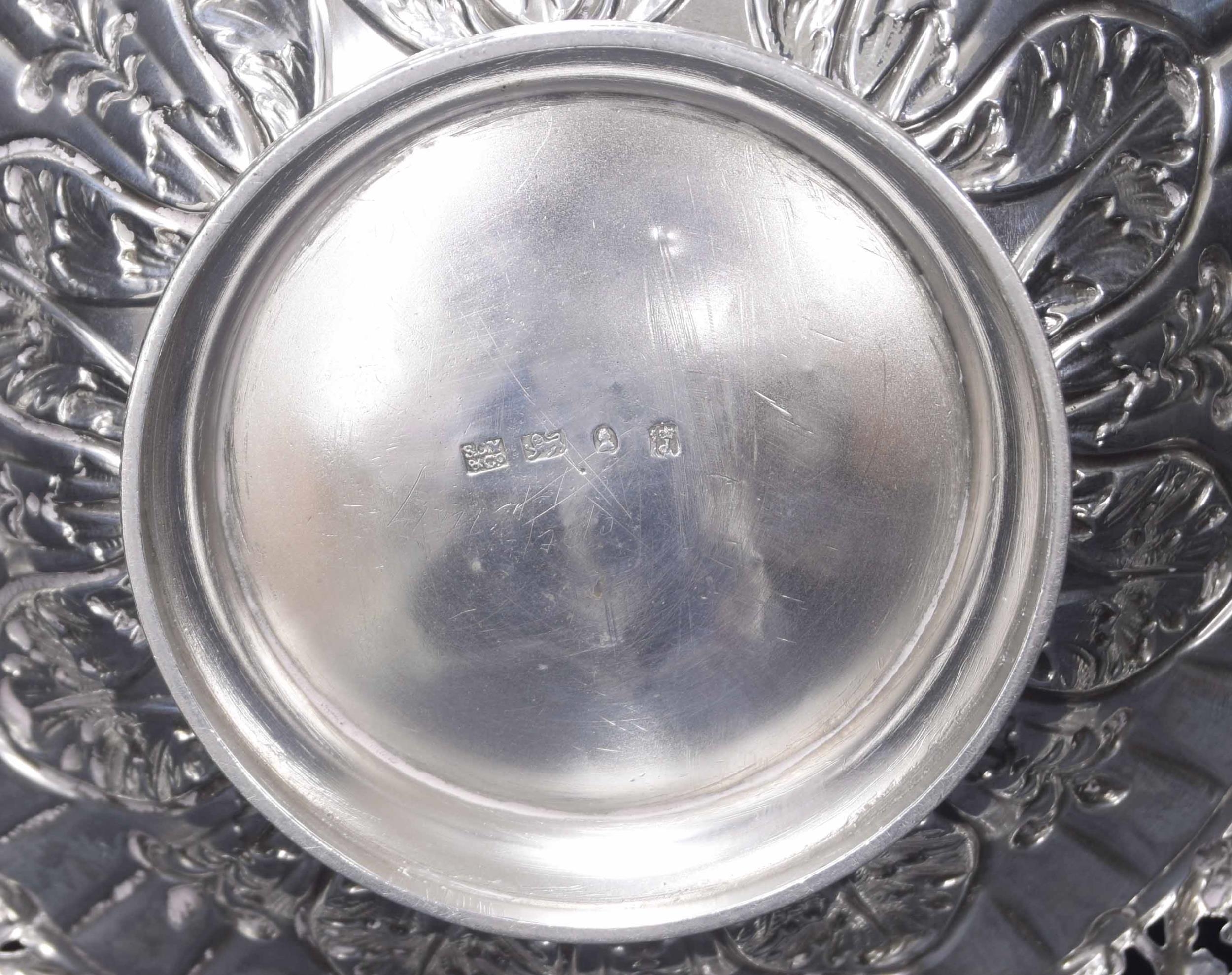 George IV silver basket, cast with pierced vine borders around foliate repousse centre raised on a - Image 2 of 2