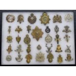 Military Regimental cap badges - collection of thirty-three examples mounted in a display frame,