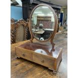 Georgian oval mahogany dressing mirror, the crossbanded oval frame and scroll shaped supports over a