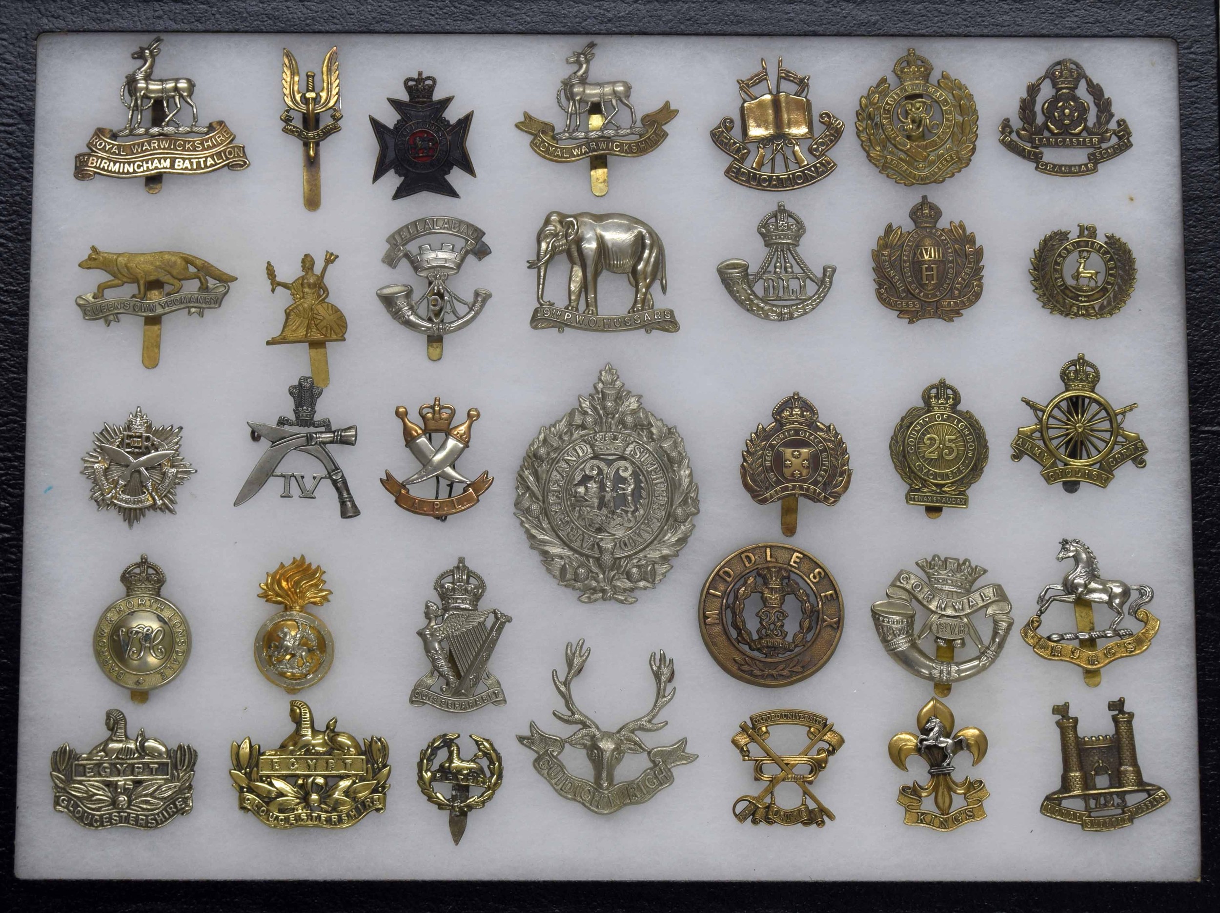Military Regimental cap badges - collection of thirty-four examples mounted in a display frame, 16.