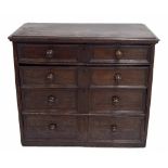 Early 18th century and later English chest of four long double panelled drawers, with later turned