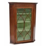 Georgian mahogany corner cabinet, the moulded cornice over an astragal glazed door enclosing