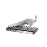 Silver plated figure ''The Pockeridge Peacock', mounted upon a black slate plinth, titled to the