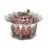 Victorian pierced silver dish and cover with cranberry glass liner, the cover with cast floral