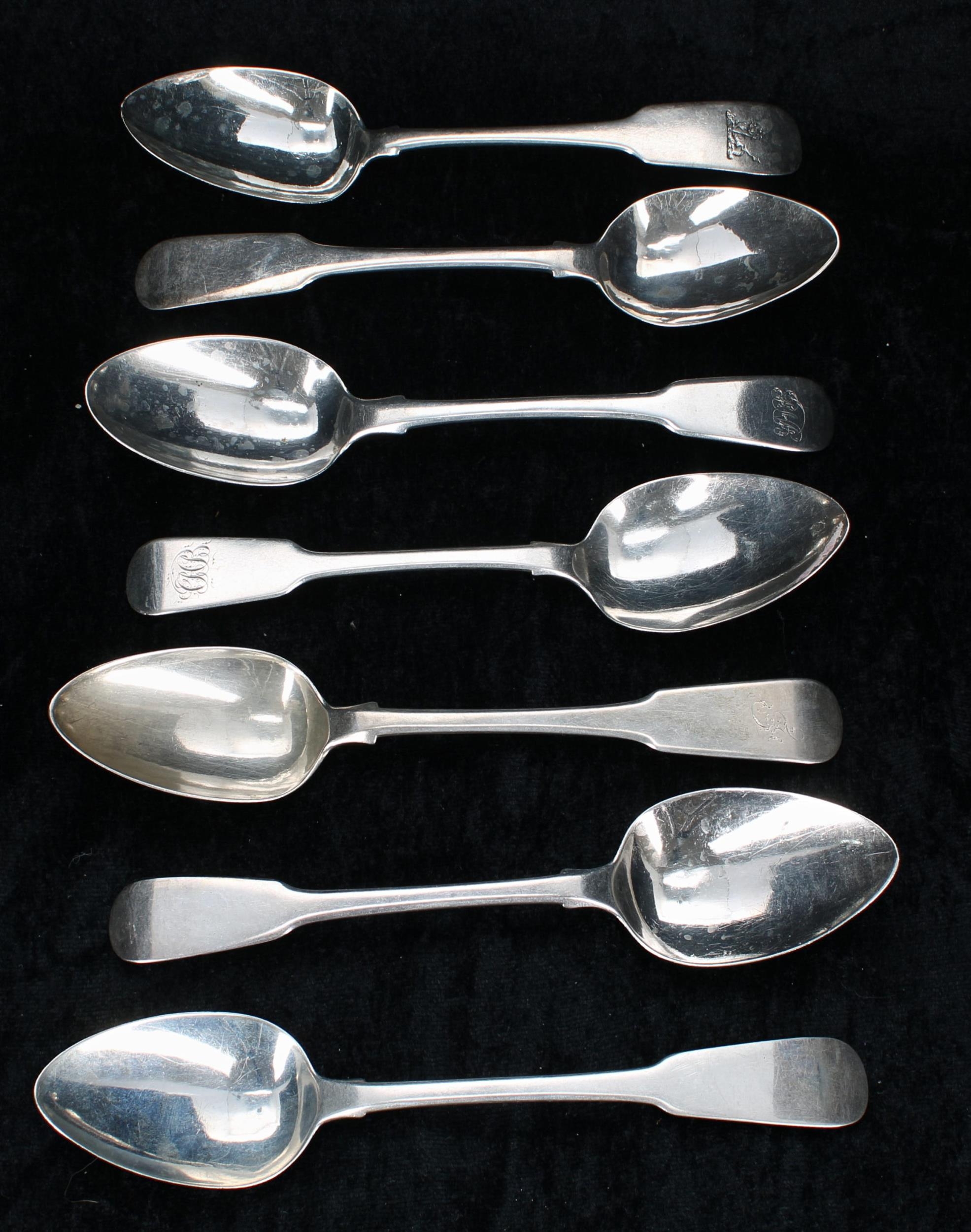 Seven similar Georgian silver fiddle pattern dessert spoons, two with rat tail to the underside of