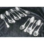 Thirteen Victorian silver dessert spoons, seven by Charles Wallis, London 1853, deer crest to the