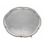 George V cast silver salver of lobed form with reeded edge border, foliate engraved decoration to