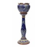 Royal Doulton stoneware jardiniere on stand; the jardiniere with wavy rim, decorated with raised