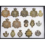Military Regimental cap badges - selection of fifteen examples mounted in a display frame, 16.25"