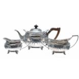 Victorian silver three piece tea set, half reeded with cast shell rim borders, the teapot with