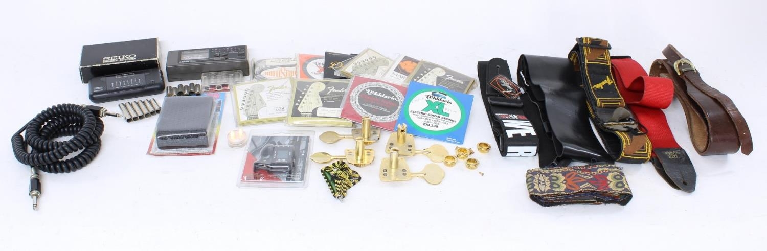 Selection of miscellaneous guitar accessories to include a Fender and other guitar straps, a