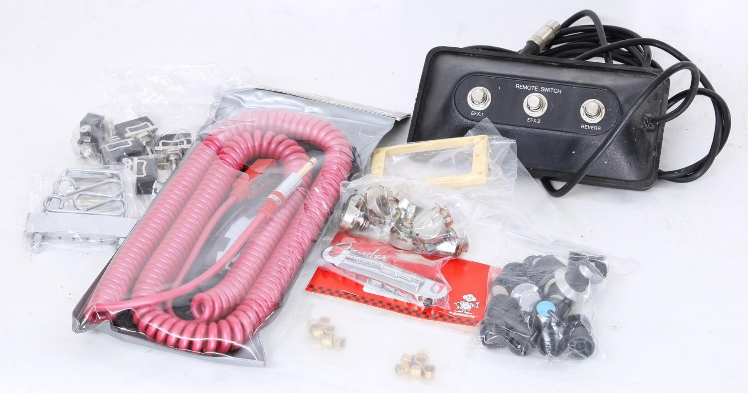 Quantity of guitar spares to include an unopened Vox coiled jack cable, a Peavey amplifier foot