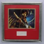 Jimi Hendrix - autographed page, mounted and framed beneath a colour picture, 17" x 17"