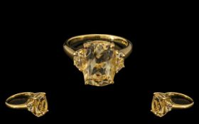 Citrine and White Topaz Ring, an elongated cushion cut citrine of 6cts, flanked by two .5ct D cut