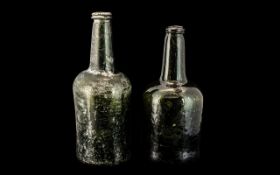 Two 18th Century Green Glass Wine Bottles with moulded tops and long necks.